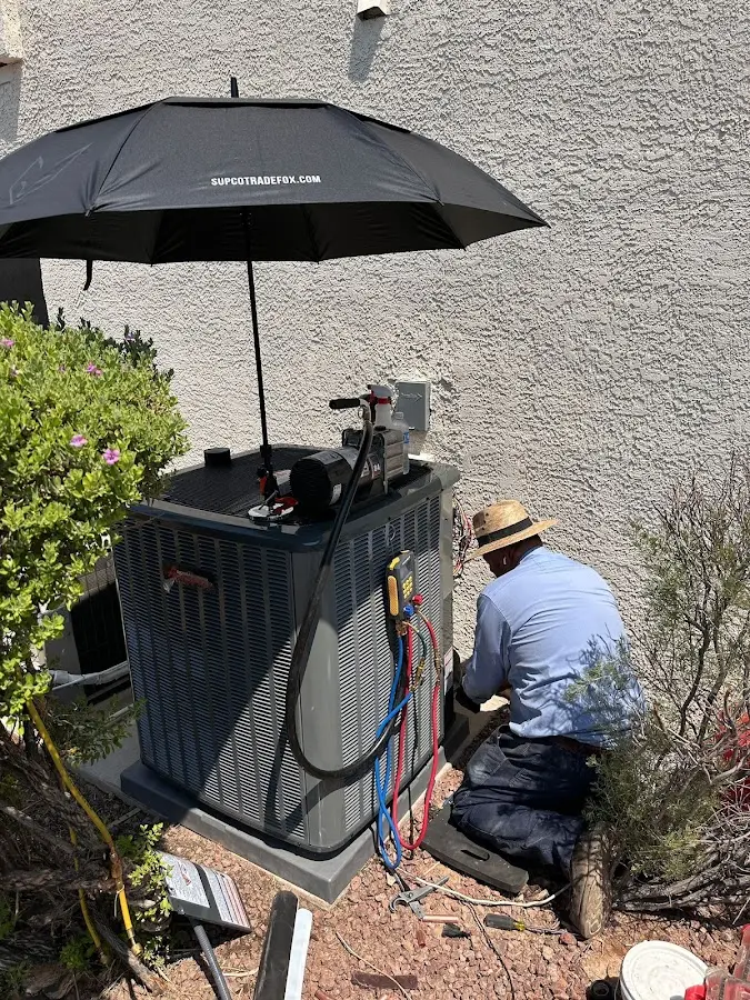 HVAC technician performing outdoor AC maintenance in Princeton